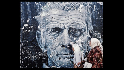 Photo of people infront of a mural