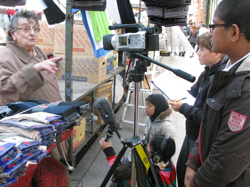 interviewing a trader on Leather Lane market